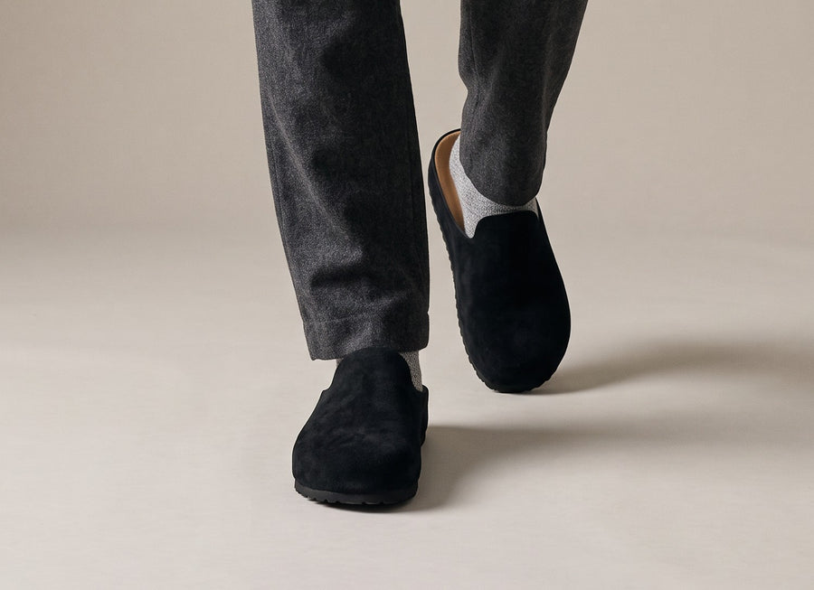 Black Suede Relief Clogs from the front, showing the rounded toe box