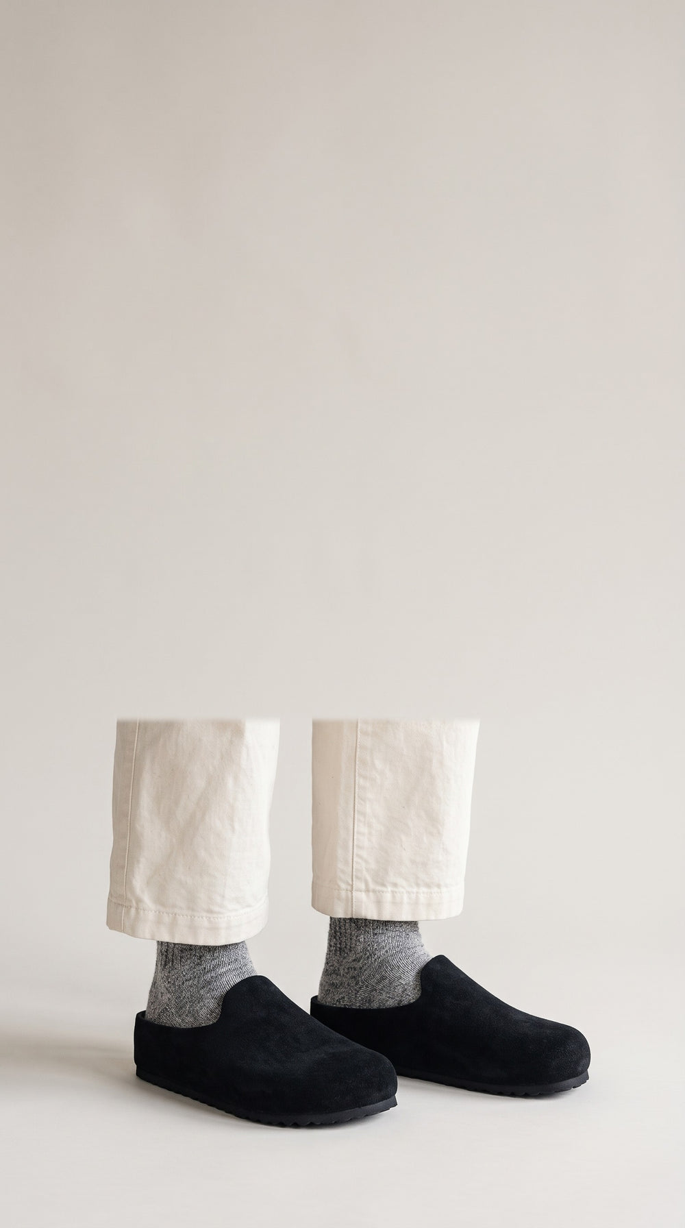 Black Suede Relief Clogs worn with grey wool socks